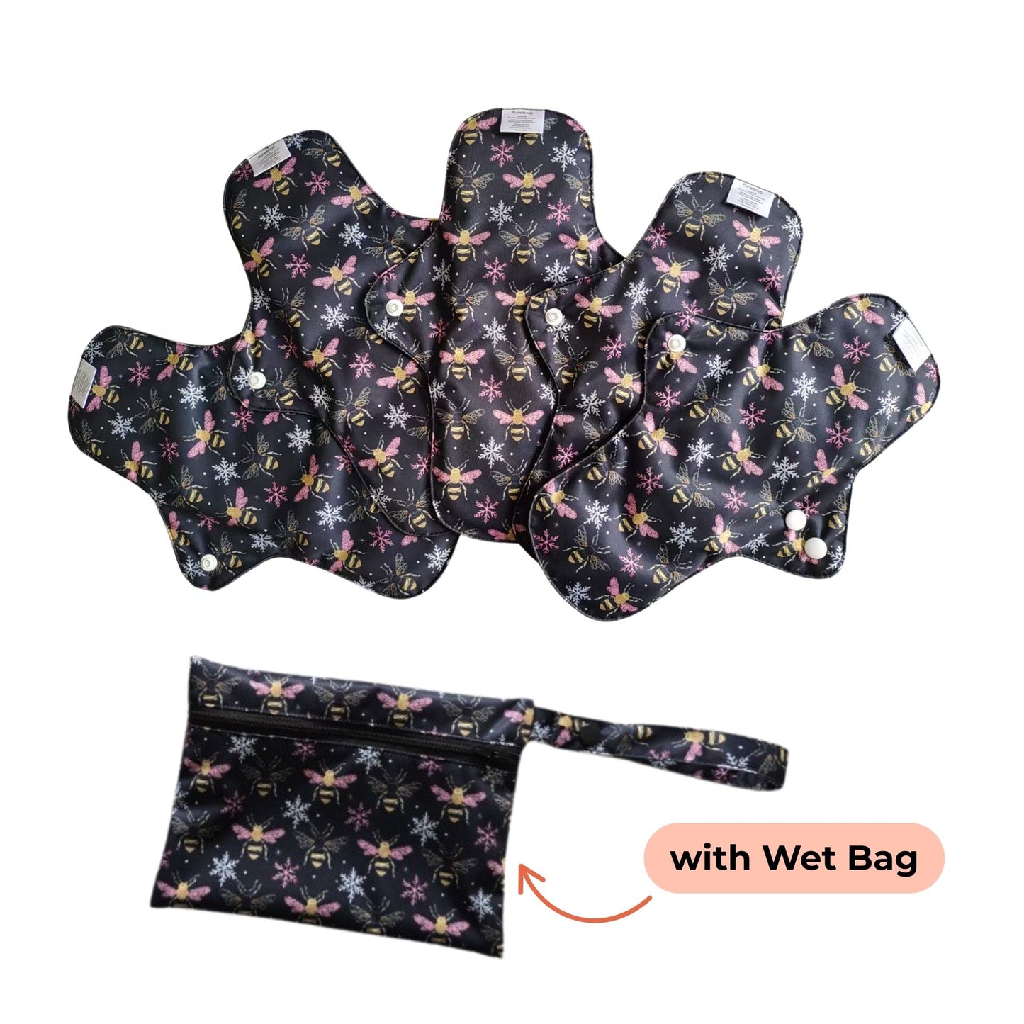 Set of PureSnug's reusable menstrual pads with a bees and snowflakes pattern are arranged in a fan shape. A matching wet bag with a zipper is included for storage.