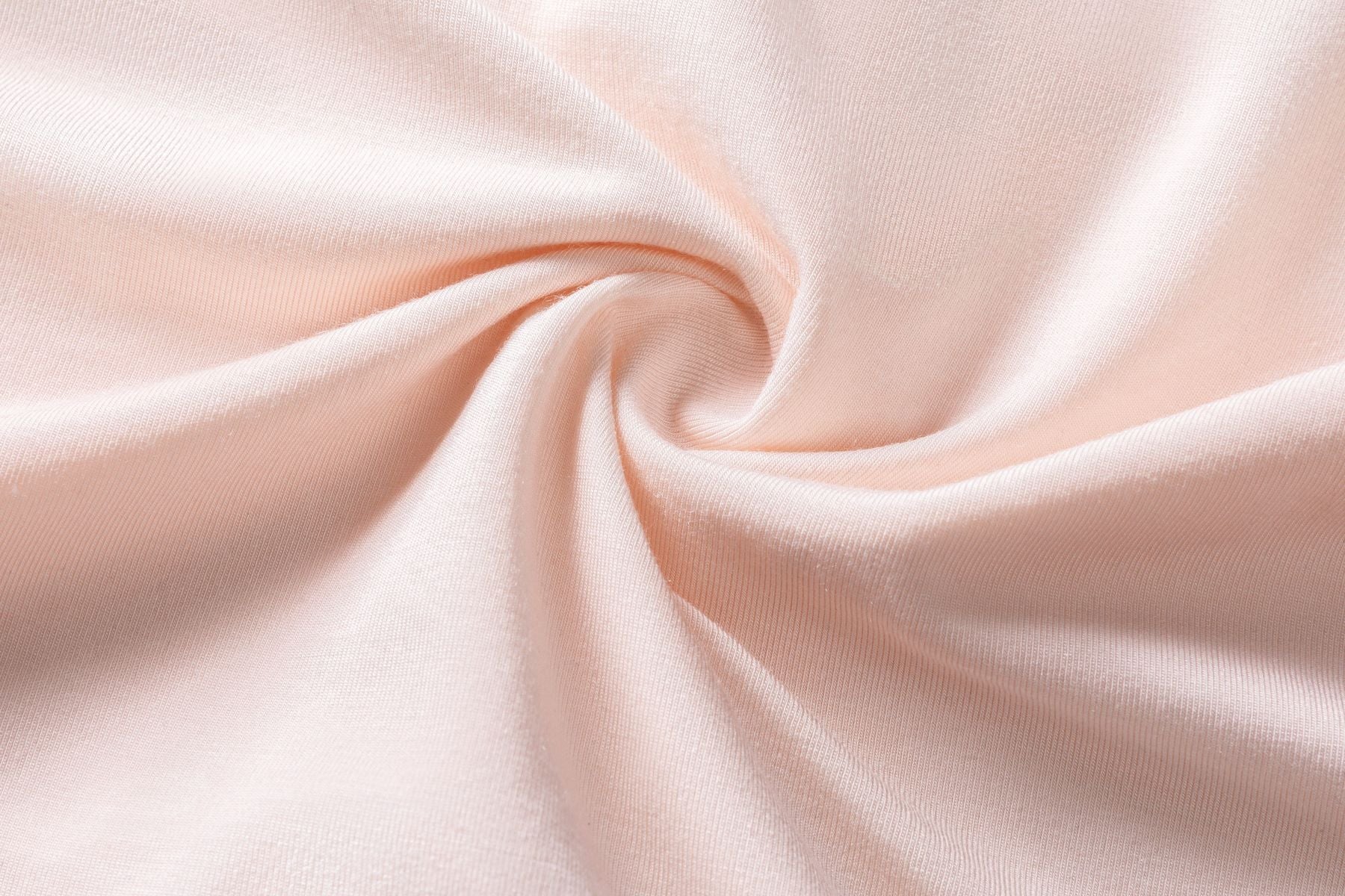 A smooth, light pink fabric with a gentle swirl design in the center.