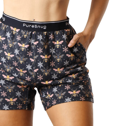 Person wearing PureSnug Bees Knees lounge shorts with bee and floral pattern, brand 'PureSnug' visible.