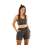 Woman wearing PureSnug Bees print crop top bra and lounge shorts set on a white background