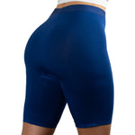 A person is wearing form-fitting blue biker shorts from a back view, showcasing a smooth texture and high waistband.