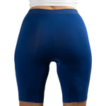 A person is wearing tight-fitting, high-waisted blue compression shorts, viewed from the back.