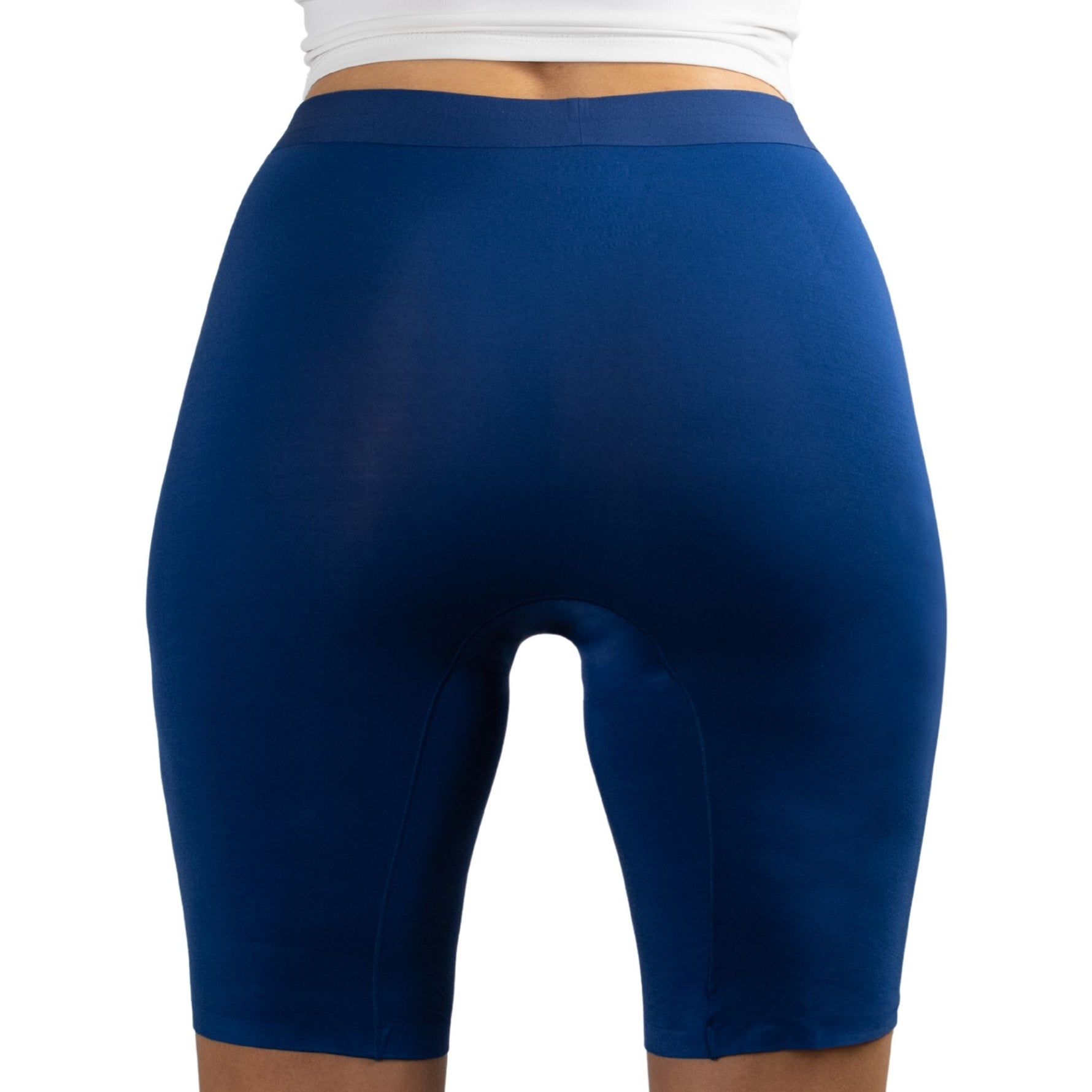 A person is wearing tight-fitting, high-waisted blue compression shorts, viewed from the back.