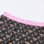 Black lounge shorts with bee and snowflake pattern and pink waistband, featuring 'PureSnug' branding.