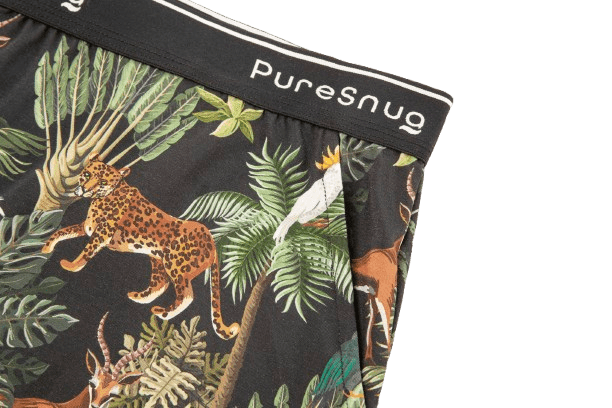 Close-up of women's lounge short in a vibrant jungle print with animals and foliage, topped with a black PureSnug waistband.
