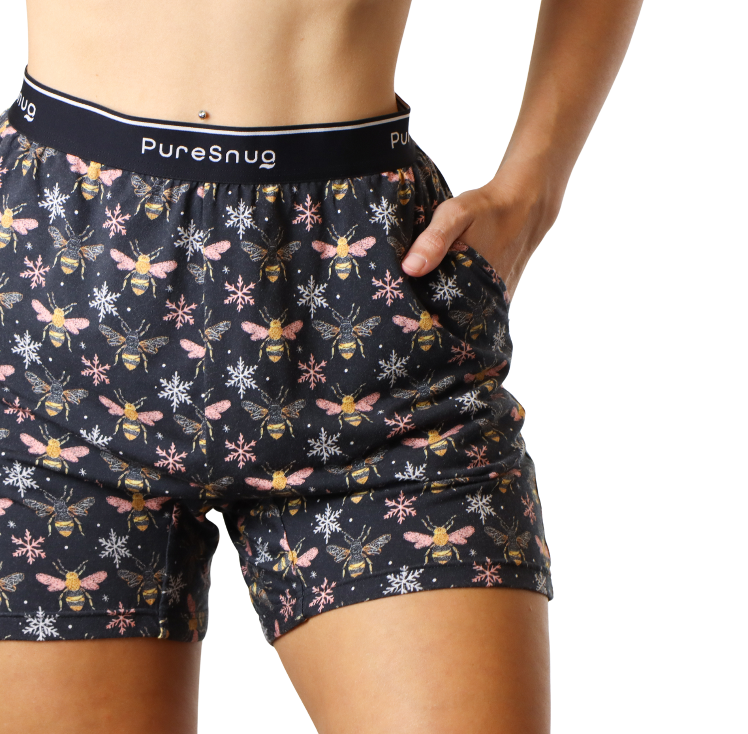 A model wearing PureSnug's patterned black shorts with bees and snowflakes designs, showcasing a fitted waist and a casual look.