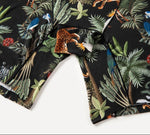 Hem detials featuring a vibrant jungle print with colorful birds, leopards, and lush green leaves on a black background.