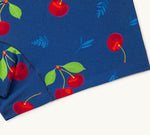 Close-up of navy blue fabric featuring a whimsical pattern of bright red cherries with green leaves.