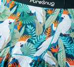 Colorful vibrant white cockatoo print, featuring bright orange crests, surrounded by lush green leaves and tropical flowers.
