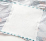 Soft light fabric with pastel blue trim and a textured white patch, simple and clean.