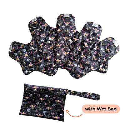 Set of PureSnug's reusable menstrual pads with a bees and snowflakes pattern are arranged in a fan shape. A matching wet bag with a zipper is included for storage.