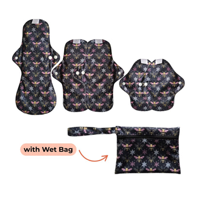 PureSnug's Reusable pads with bees and snow flakes print, including a wet bag for storage, displayed in a flat layout.