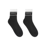 Black ankle socks with white ribbed cuffs, featuring a "Puresnug" logo on the front, styled for comfort and casual wear.