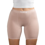Close-up of person wearing Blush Beige nude seamless PureSnug boxer brief with logo waistband