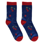 Blue socks featuring vibrant red cherries and green leaves, with contrasting red heels and cuffs, creating a cheerful design.