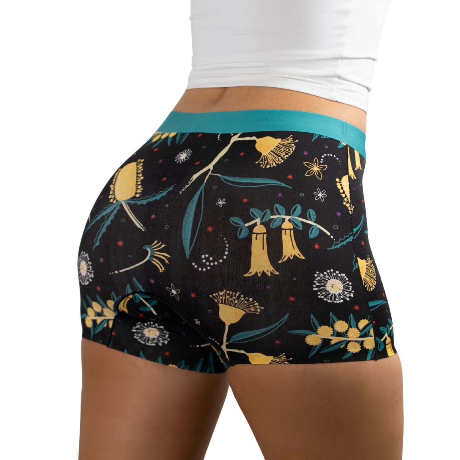 Close-up of woman wearing PureSnug Golden Snug floral-patterned boyshorts with colorful print
