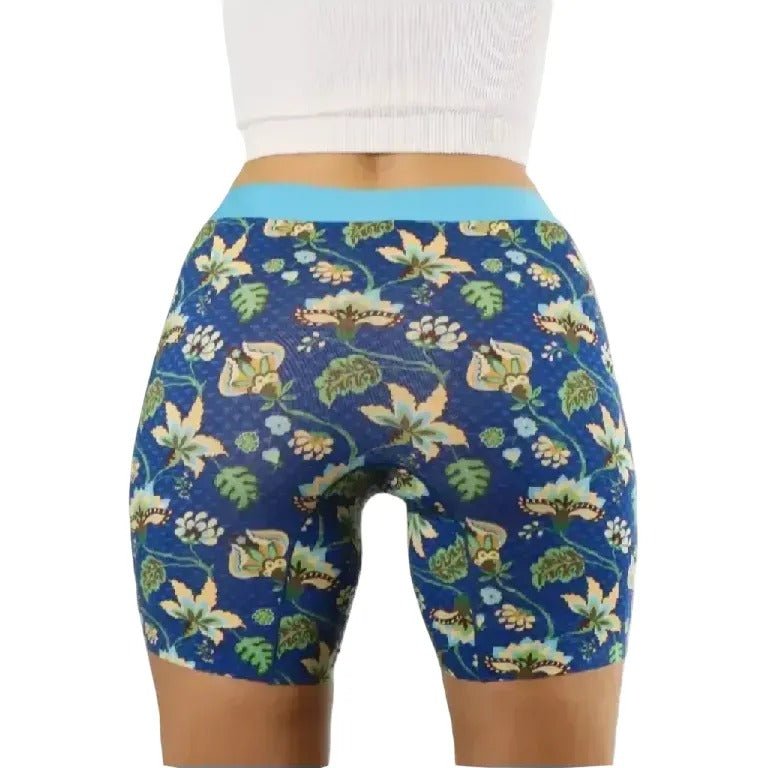 Close-up of PureSnug vibrant blue fabric with colorful floral patterns, softly folded for texture.