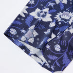 Close up look of the hem in navy blue fabric with white floral 