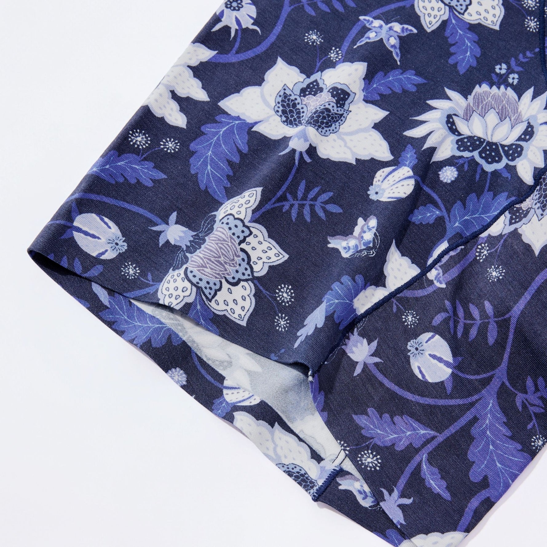 Close up look of the hem in navy blue fabric with white floral 