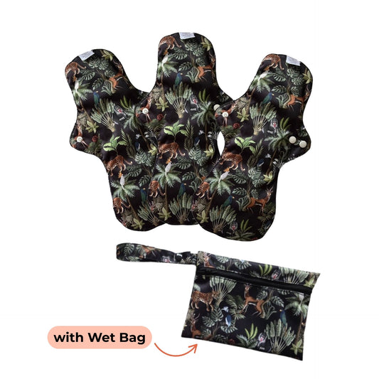 PureSnug's reusable night pads with tropical jungle print featuring leaves and animals. Includes a matching wet bag for convenient storage.