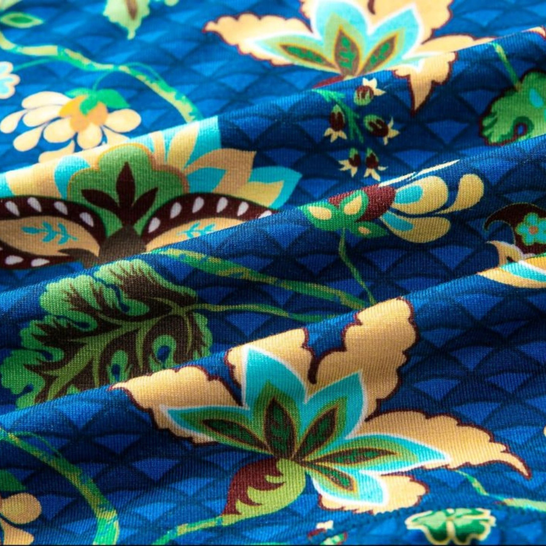 Close-up of a midnight blossom colorful floral quilt with blue background