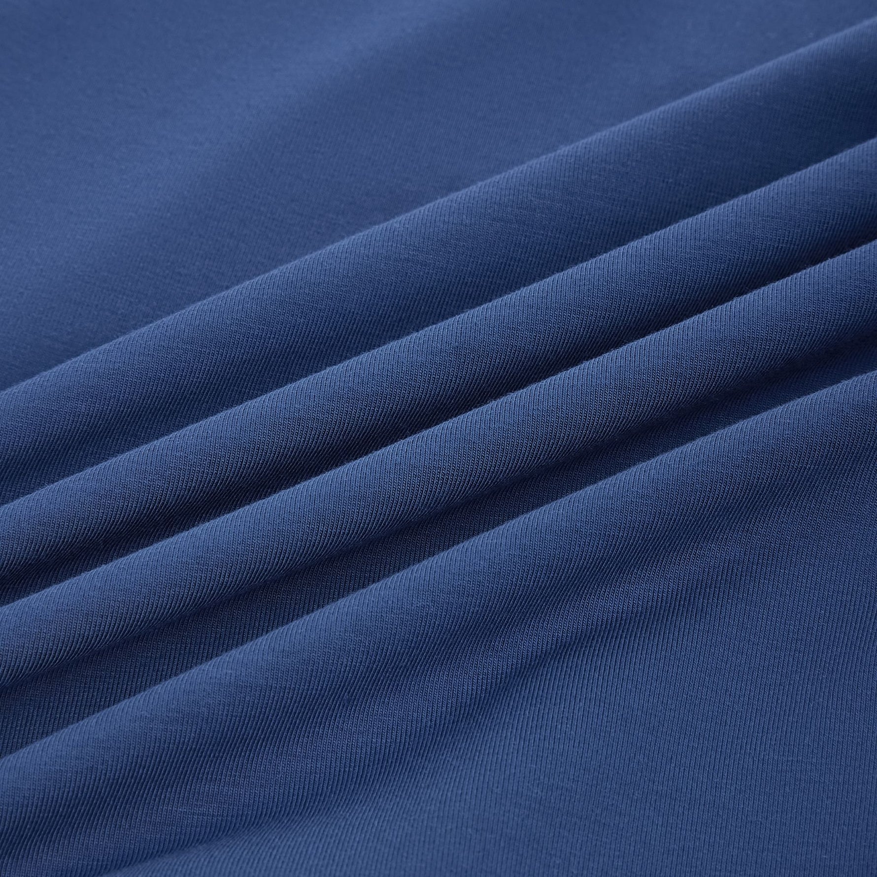 Close-up of PureSnug’s navy lounge short modal fabric with gentle diagonal folds, highlighting its soft texture