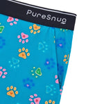 Close-up of PureSnug’s “Pawfect” lounge shorts in a bright blue modal fabric with colorful paw prints and a black waistband