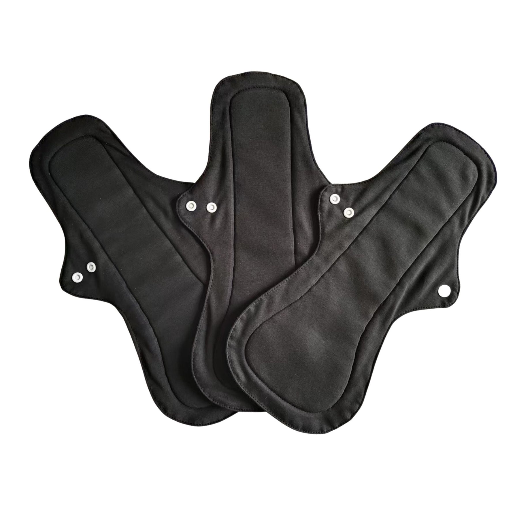 Three eco-friendly black reusable cloth night pads are arranged overlapping, displayed on a white background. Each pad has snap buttons on the wings for secure attachment.