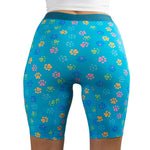 A model wearing PureSnug's High-waisted biker shorts with colorful paw prints and heart designs.