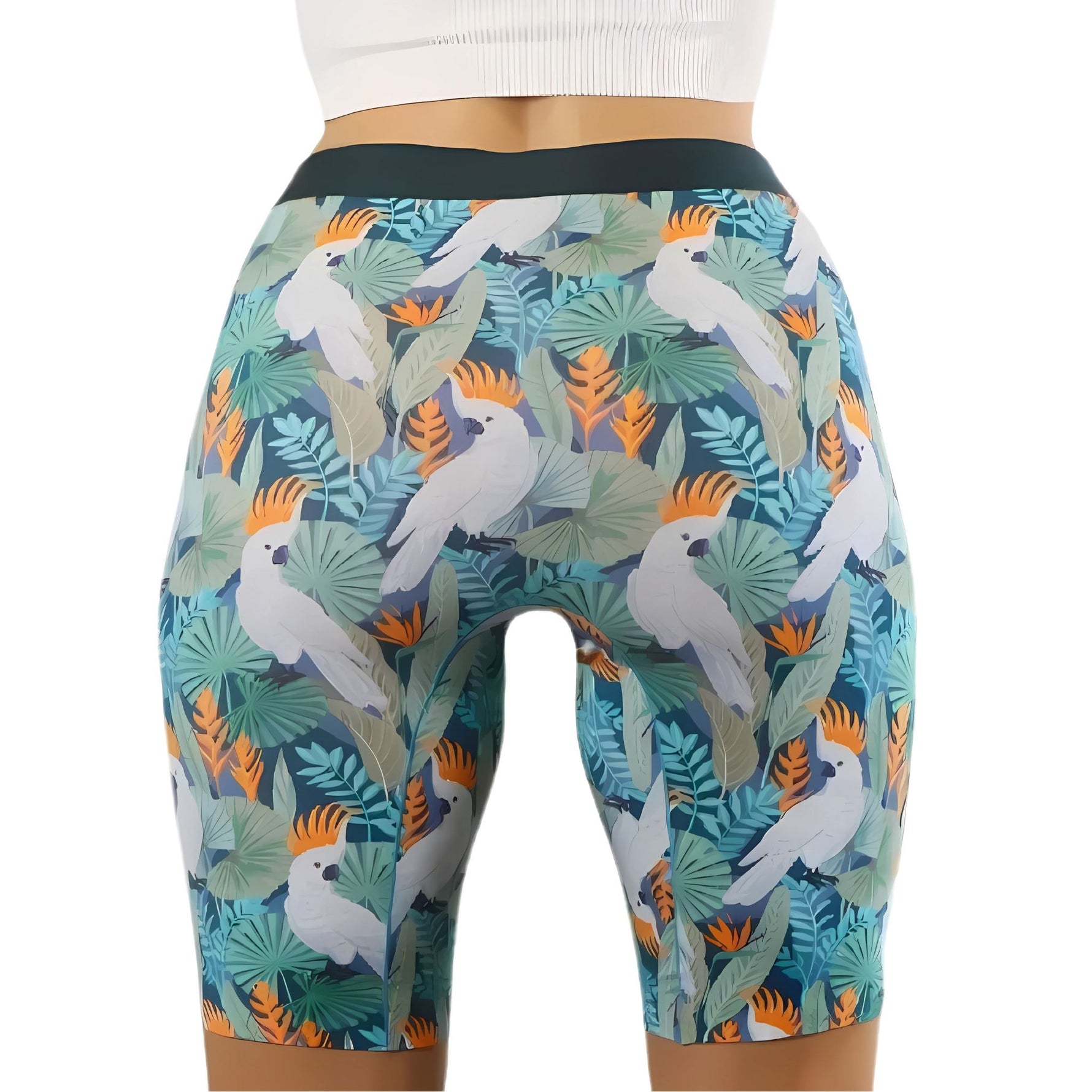 Person wearing tropical cockatoo-print shorts with green leaves, paired with a white cropped top.