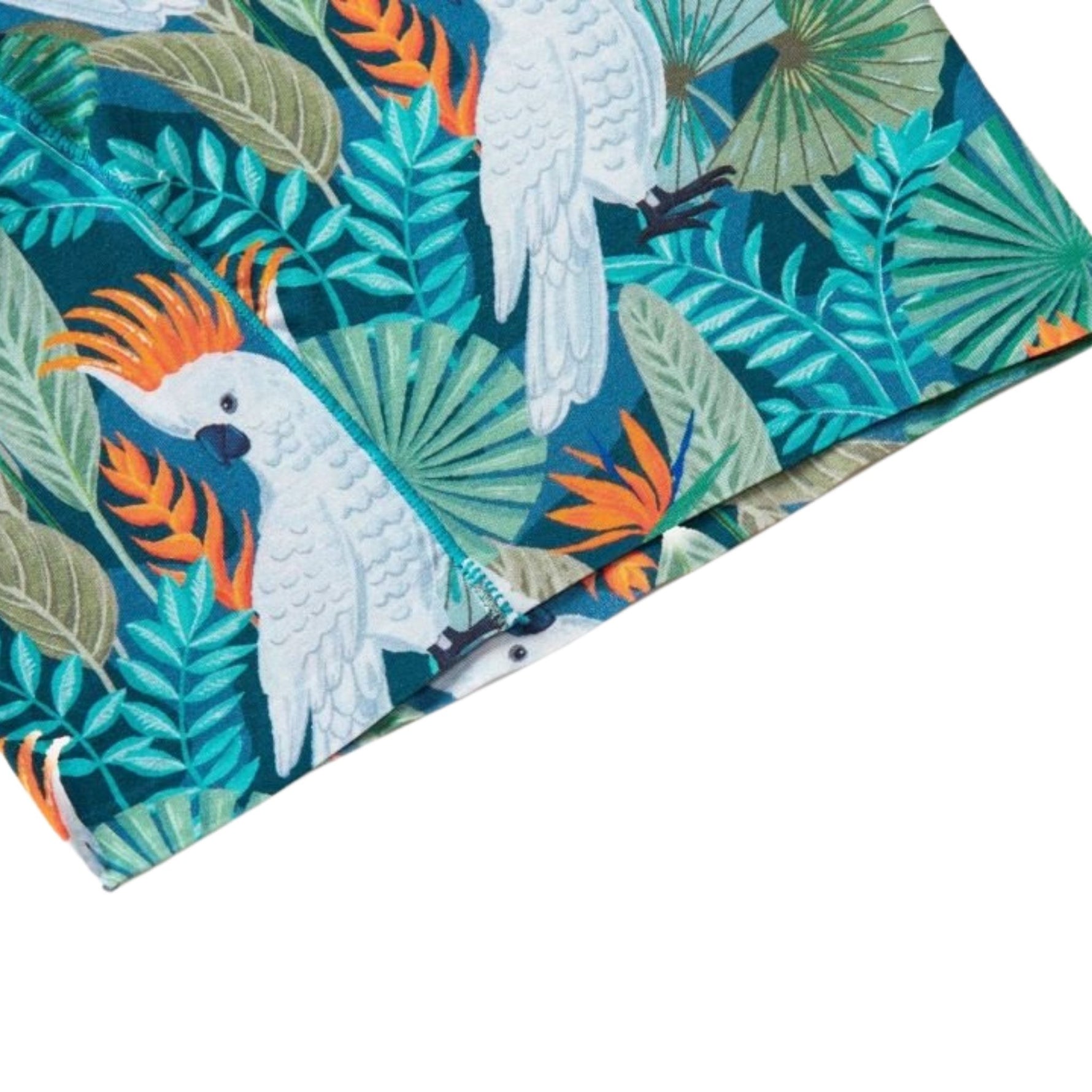 Fabric with tropical leaf and parrot pattern on a blue/green background