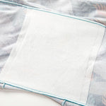 Soft light fabric with pastel blue trim and a textured white patch, simple and clean.