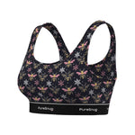 A women's sports bra by PureSnug featuring a dark navy black base with an all-over print of yellow and black bumblebees, pink flowers, and white snowflakes. The bra has a wide, supportive underband with the brand name 'PureSnug' printed in white.