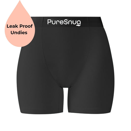 PureSnug black leakproof undies for women, mid-length boxer brief style with full front-to-back leakproof panel, waistband logo, and comfortable leg coverage.