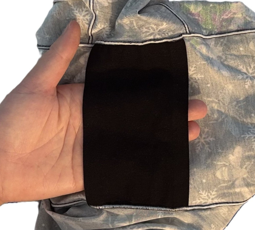 Hand holding a black organic cotton floating gusset of pure snug underwear