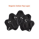 5 set of PureSnug's black reusable panty liners with white snaps are arranged against a white background. Above them, orange text reads “Organic Cotton Top Layer.”