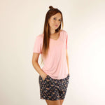 A woman wears a soft v-neck Tee in pink colour, and a soft lounge shorts in bees prints.
