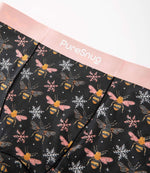 Close-up of PureSnug’s Bees print leakproof underwear featuring a soft pink waistband and breathable modal fabric with a bee and snowflake pattern.