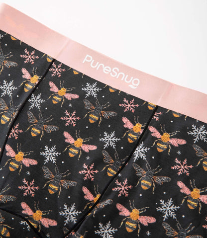 Close-up of PureSnug’s Bees print leakproof underwear featuring a soft pink waistband and breathable modal fabric with a bee and snowflake pattern.
